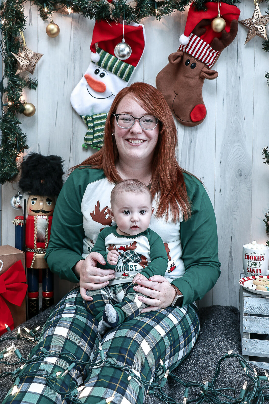 A photo from the Kay Christmas Mini Shoot, shot in Port Wade, Nova Scotia on wintery morning inside with Christmas tree, stockings and nutcrackers.